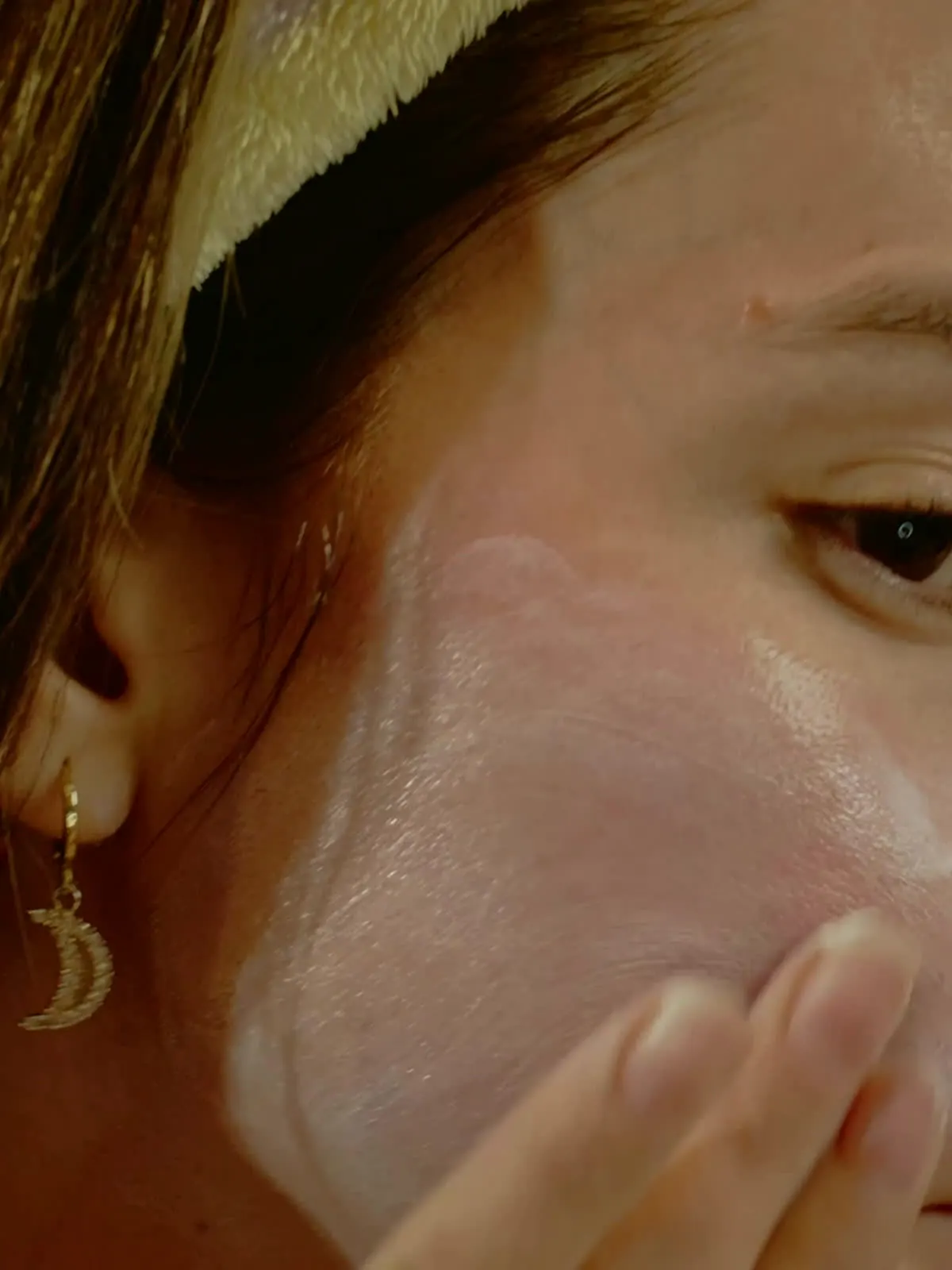 Cream pressed into the cheek in soft morning light